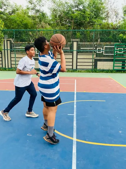 A player takes a shot, focusing on his form.