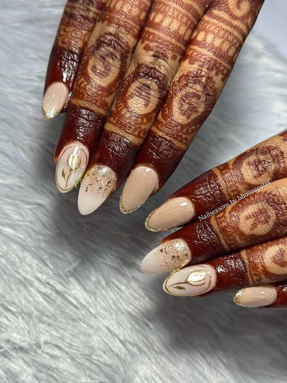 A stunning bridal set designed to complement her golden outfit. We used a mix of cat eye, chrome, ombre, and glitter French tips for a truly unique look.