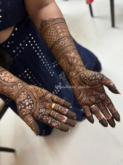 Another angle of the same full bridal mehendi, showcasing how the design looks from the side. The patterns are consistent and detailed all the way around the arm.