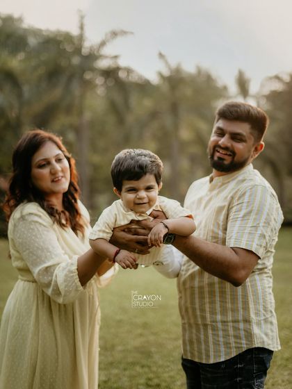 Look at that smile! By letting parents hold and interact with their child naturally, I can capture their little one's personality shining through. This is a perfect example of a relaxed, candid family portrait.