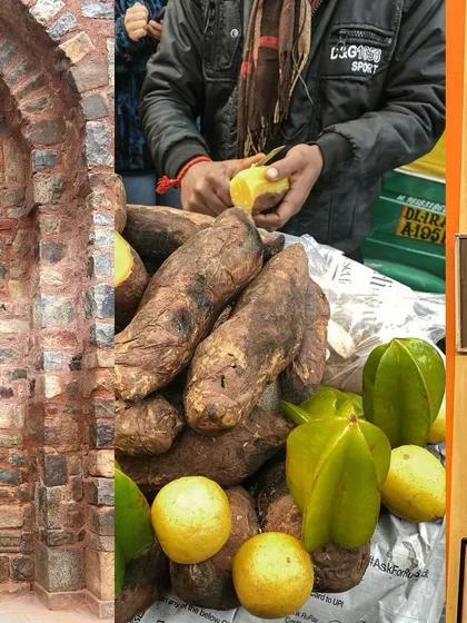 A street vendor in Delhi peeling and selling sweet potatoes and starfruit.