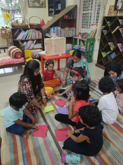 Another view of the origami session, with the storyteller providing step by step guidance.