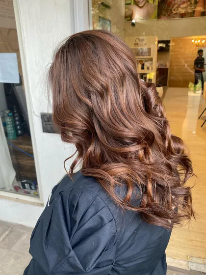 A gorgeous, warm-toned global hair color. This single-process color gives a rich, uniform look with incredible shine, styled here with bouncy curls.