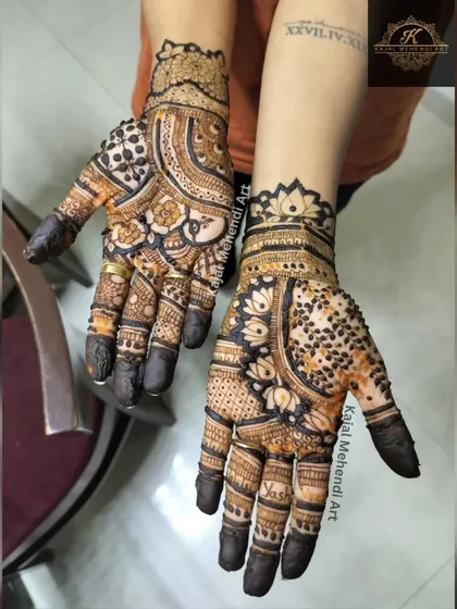 Another view of this popular 'sider' mehndi style. The contrast between the filled-in fingertips and the detailed palm work is very striking.