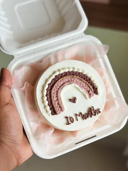Sometimes the smallest cakes hold the biggest emotions. Our bento cakes are perfect for celebrating monthly milestones, anniversaries, or just because. This little cake marks ten months of joy, decorated with a textured buttercream rainbow.