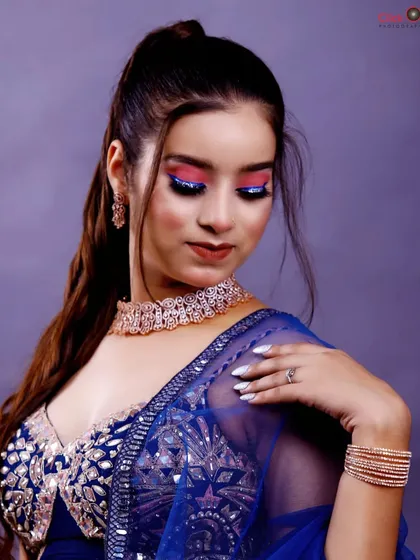 A beauty close-up highlighting the model's dramatic eye makeup and jewelry. This type of shot is essential for a model's portfolio, showcasing their features and versatility.