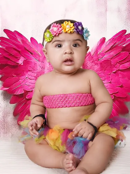 A colorful fairy theme shoot with bright pink wings and a rainbow tutu. I have many different wing and costume options in my collection to create a magical look.