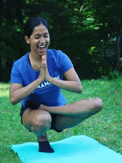 This is the vibe of my classes. We move, we breathe, and we definitely laugh. This moment of joy in a toe-stand balance captures the playful, no-judgment atmosphere I love to create. It’s about finding your balance, even if you wobble.