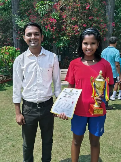Tamanna Nair receiving her winner's trophy and certificate at the NMSA tournament.