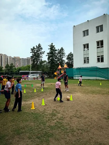 Young players participating in a cone drill during a football workshop. We use fun and effective drills to teach the basics of football to beginners.