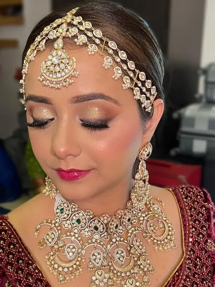 A detailed close-up of the eye makeup. I used a brilliant gold glitter on the lids, paired with a sharp liner and a bright pink lip for a festive look.