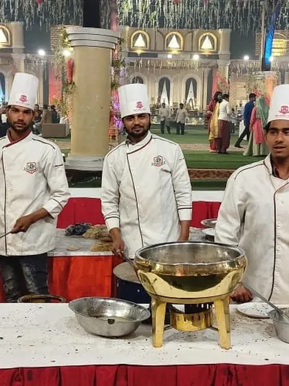 My professional chefs at a live cooking station during a wedding celebration. Dressed in clean uniforms, they are ready to serve hot, freshly prepared vegetarian dishes to all your guests.