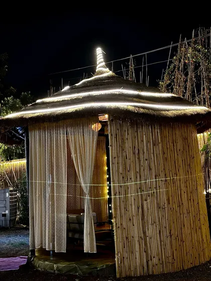 Another one of our bamboo cabanas, lit up at night. The design provides privacy while still allowing you to feel the open air and evening breeze.