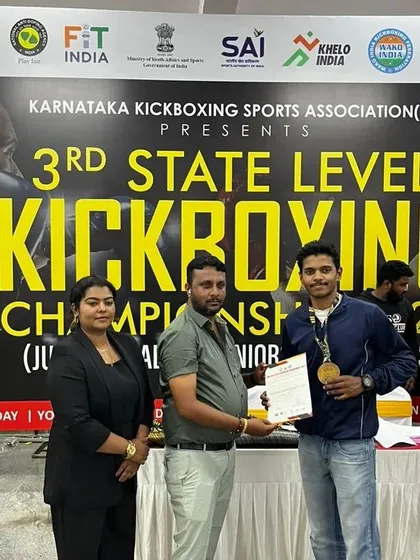 Here I am receiving an award on behalf of the academy at the state kickboxing championship. This is a win for our entire team.