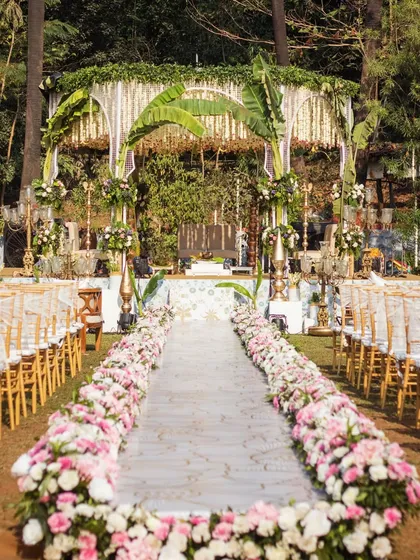 This South Indian mandap is a tribute to tradition. I used classic elements like banana leaf arches, intricate floral hangings, and a flower-lined aisle to create a space that feels both grand and divine.
