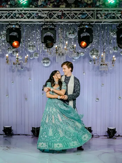 The couple's first dance at their Sangeet, under a ceiling of disco balls and chandeliers. We capture the romance and the beautiful decor of the evening.