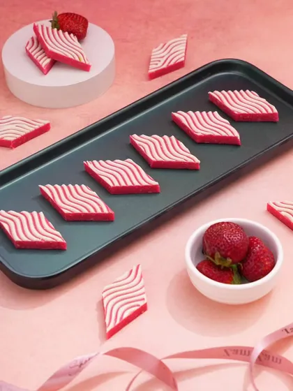 I used a clean, minimalist setup to make these strawberry-striped sweets the star. The simple arrangement on a dark tray against a light background makes the unique pattern and vibrant color pop.
