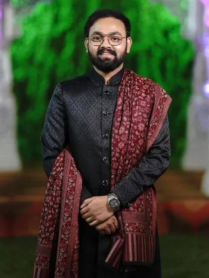 A close up of our black quilted Jodhpuri suit, paired perfectly with a traditional printed shawl. This outfit is a great choice for wedding guests who want a classic yet stylish look. The fit and fabric feel premium.