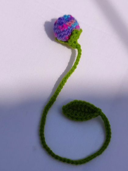 A single multi-colored tulip bookmark, showing how the variegated yarn creates a unique pattern.