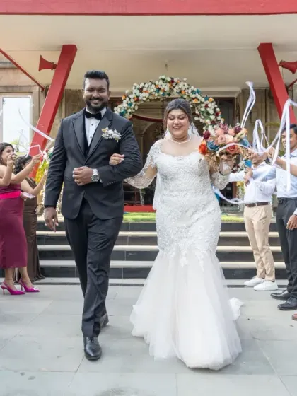 The grand exit from the church, with friends creating an arch of ribbons. This is a fun and celebratory tradition that makes for a fantastic, dynamic photograph.