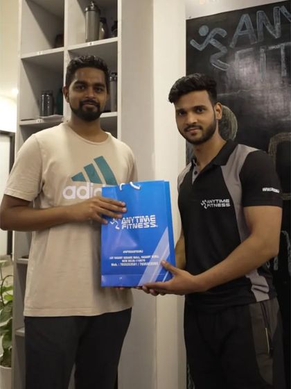 Another milestone celebration. A trainer presents a loyal member with a gift to mark his anniversary with our gym.