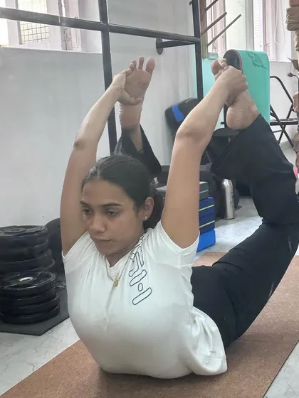 A student demonstrating a beautiful Dhanurasana (Bow Pose) during our mentorship workshop. This pose requires open shoulders and a strong back, and her form is a testament to dedicated practice.