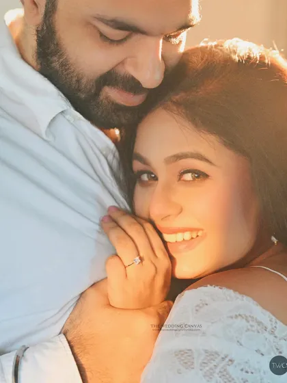 Sun-kissed and full of joy. This portrait uses natural light to create a beautiful flare, highlighting the bride's happy expression as she embraces her partner.
