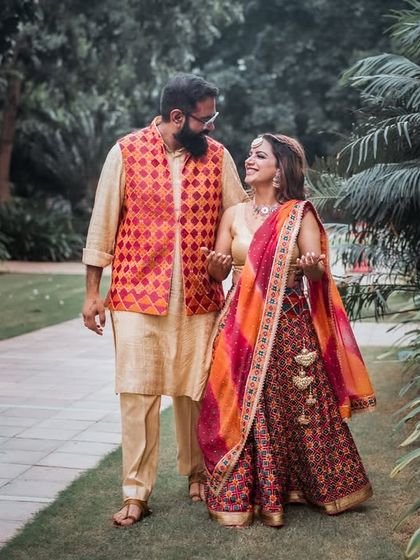 A relaxed walk through a garden during a pre-wedding event. The couple's colorful outfits and natural interaction make for a beautiful photograph.