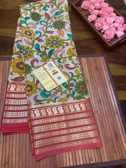 A classic floral Kalamkari print on a white Mysore silk saree with a traditional red border.