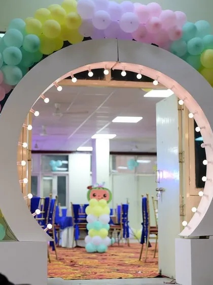 A unique circular entranceway for Advit's party, decorated with pastel balloons to welcome guests.