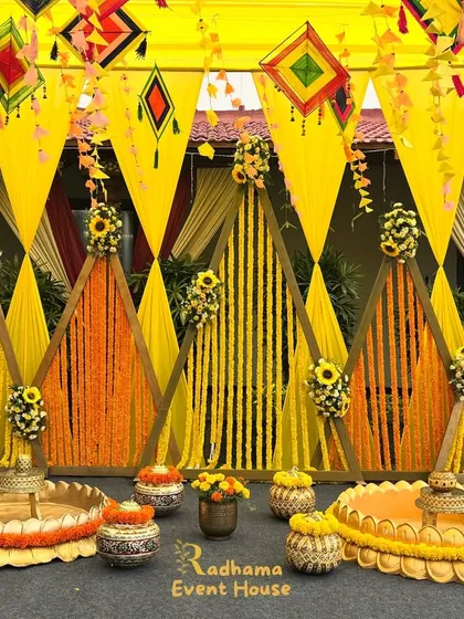 A vibrant and joyful Haldi ceremony setup, bursting with the traditional glow of yellow and orange marigolds. We designed this space with geometric backdrops, floral-filled urlis, and festive hangings to create the perfect ambiance for this fun-filled pre-wedding ritual.
