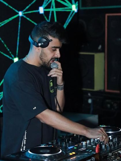 On the mic at Bombay Adda, Koramangala. I use the microphone as an instrument to interact with the crowd and amplify the energy.