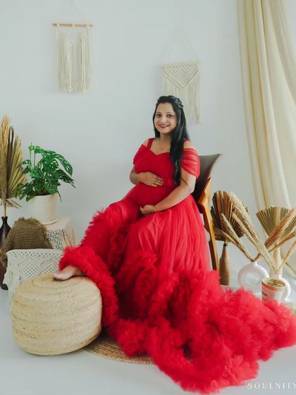 Dressed in a stunning, fiery red ruffled gown, this mother-to-be looks absolutely radiant. My studio sessions can be styled to create these glamorous, magazine-worthy portraits.