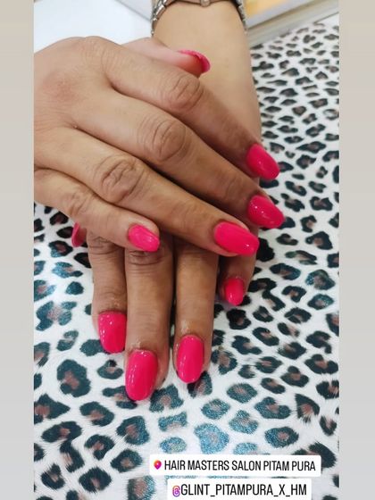 For those who love a pop of color, this bright pink gel manicure is a fantastic choice. The vibrant hue provides a cheerful and confident look on these neatly shaped nails.