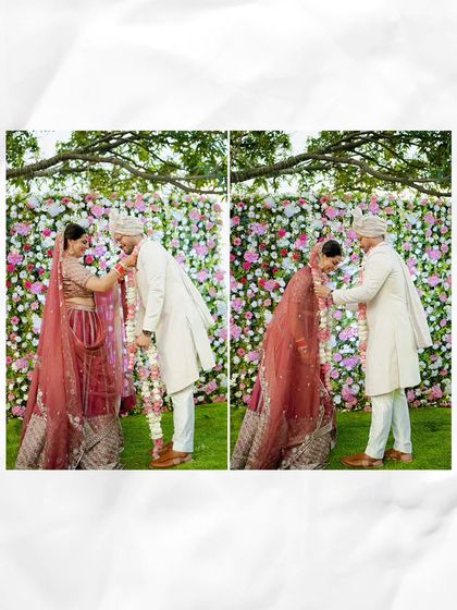 The Jaimala ceremony captured against a stunning wall of flowers, a simple and beautiful moment of exchange.