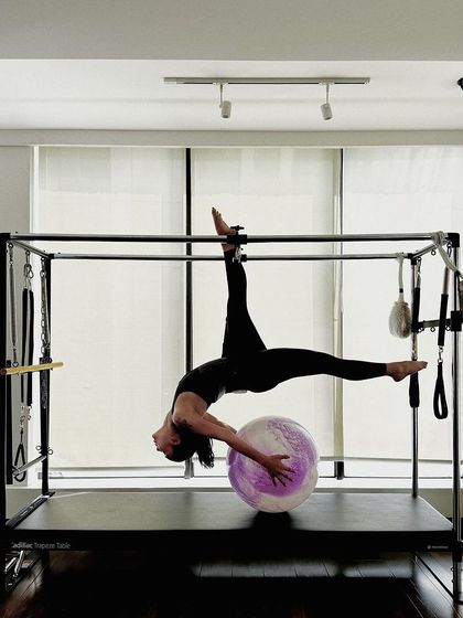 The full expression of this advanced Cadillac pose, demonstrating incredible flexibility and strength.