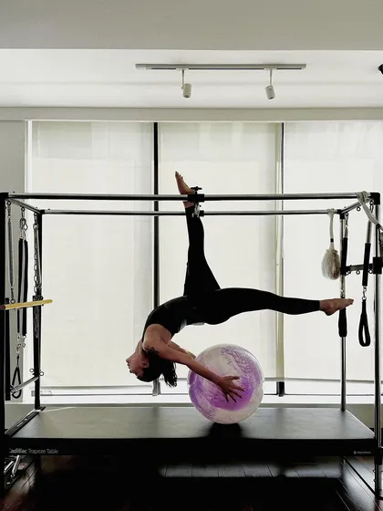 The full expression of this advanced Cadillac pose, demonstrating incredible flexibility and strength.
