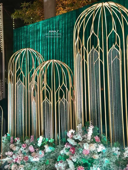 A close-up of the intricate gold "birdcage" structures, a unique and artistic element of the entrance design.