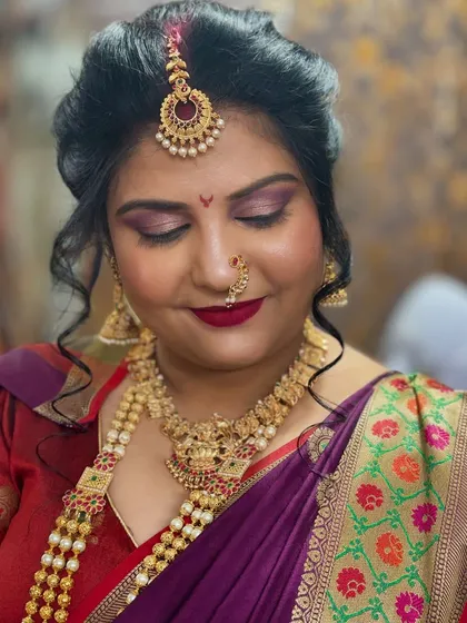 A glimpse of a traditional South Indian bridal look. The focus here is on radiant skin, beautifully defined eyes, and coordinating the makeup with the rich colors of the saree and temple jewelry.
