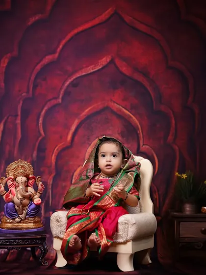 A beautiful portrait for Ganesh Chaturthi. This little girl is dressed in a traditional saree, sitting beside a Ganpati idol against a regal backdrop in my studio.