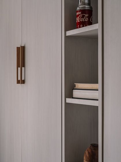 A close-up of the custom handle and shelving detail in the den, showcasing the mix of materials and attention to craftsmanship.