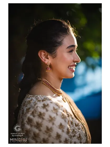 A happy, sun-kissed profile of Priyanka. The natural light beautifully highlights her glowing skin and the simplicity of her makeup, proving that less is often more.