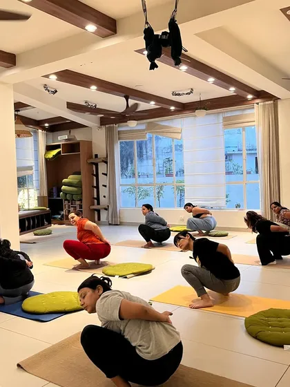 A group of students in Malasana, demonstrating the grounding and community feel of our classes.