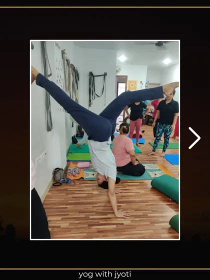 A student holds a wide-legged handstand variation, demonstrating incredible strength and control.