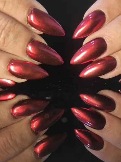 Feel the heat with these fierce stiletto nail extensions, coated in a vibrant, mirror-like red chrome finish that reflects light from every angle.