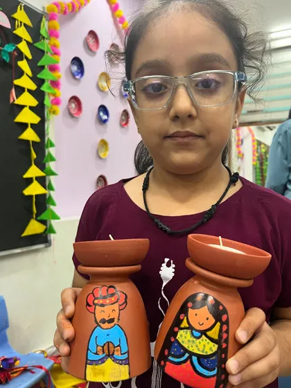 This student painted a unique set of tea-light holders featuring a man and woman in traditional attire.