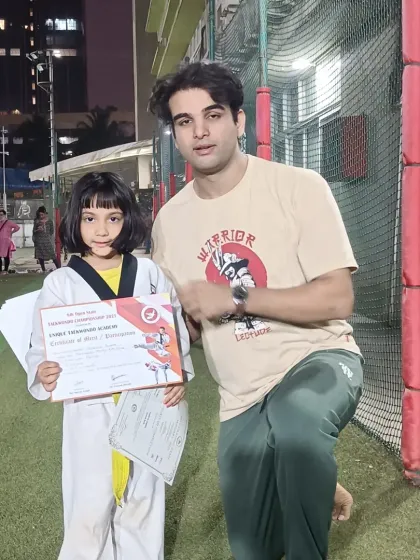 A young student from Billabong High International School proudly displays her championship certificate. We train champions from all over Mumbai.