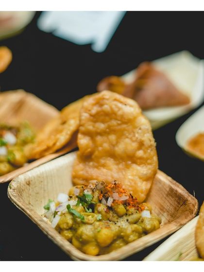 A close up of individual portions of ghugni chaat served in eco friendly leaf bowls. We combine authentic taste with thoughtful, modern presentation for our classic Indian street food offerings.