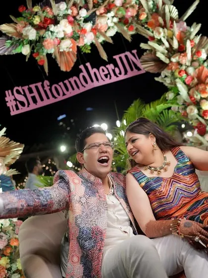 A candid moment of laughter from the couple at their vibrant carnival event. Their joy is the centerpiece of the celebration.