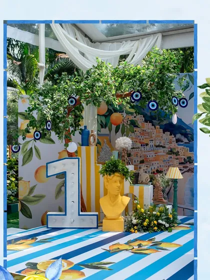 Bringing the sunshine of the Amalfi Coast to a first birthday celebration. This vibrant setup features custom backdrops, lemon trees, and bright, cheerful colors to create a feeling of 'la dolce vita' for the little one's special day.